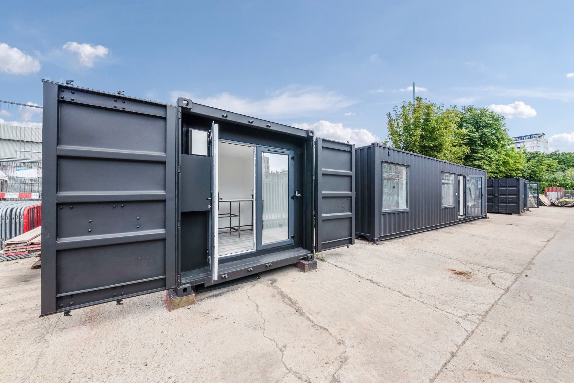 20 ft container conversion with container doors open revealing bi-fold glazing