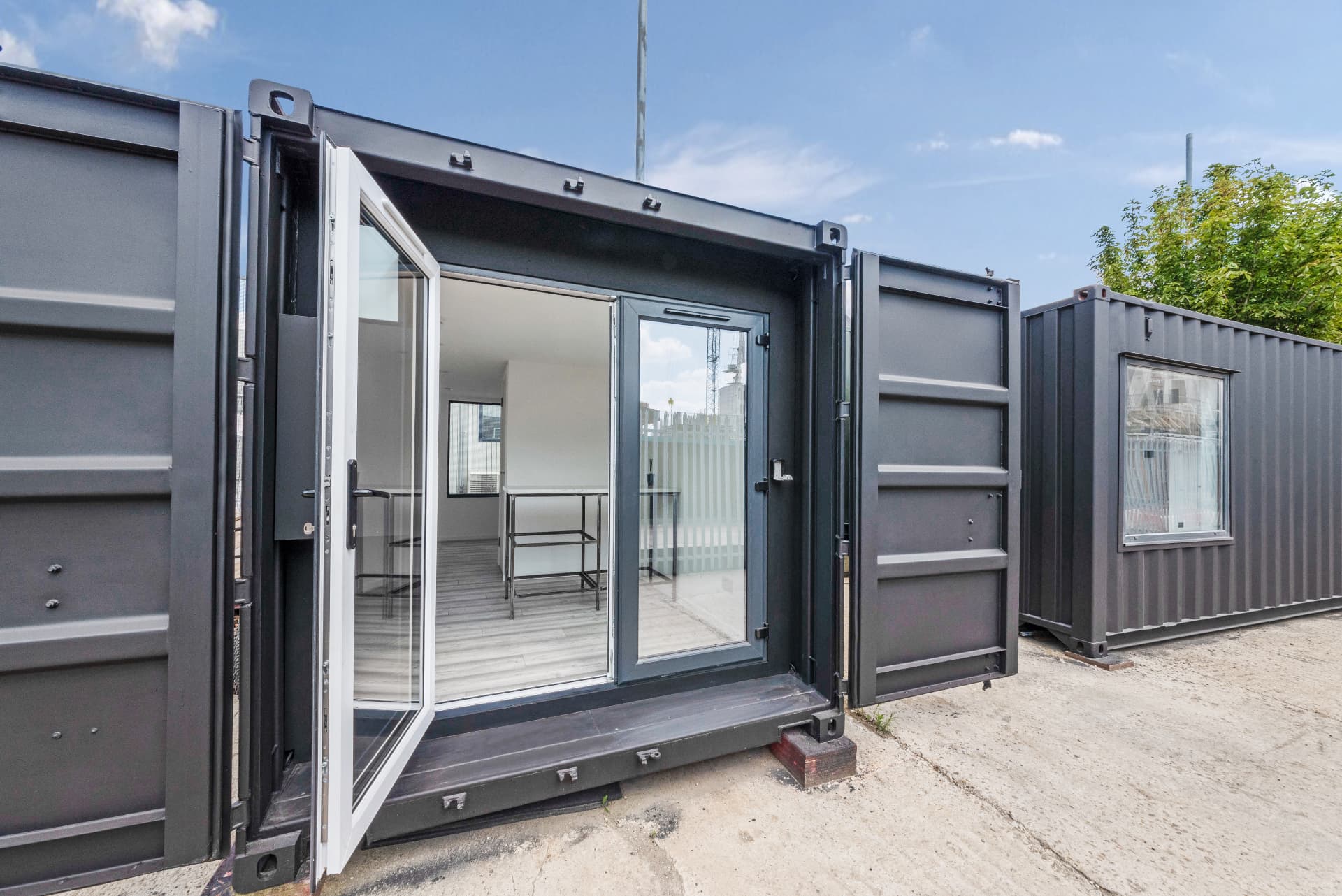 Close view of bi-fold glazed doors on a 20 ft container conversion