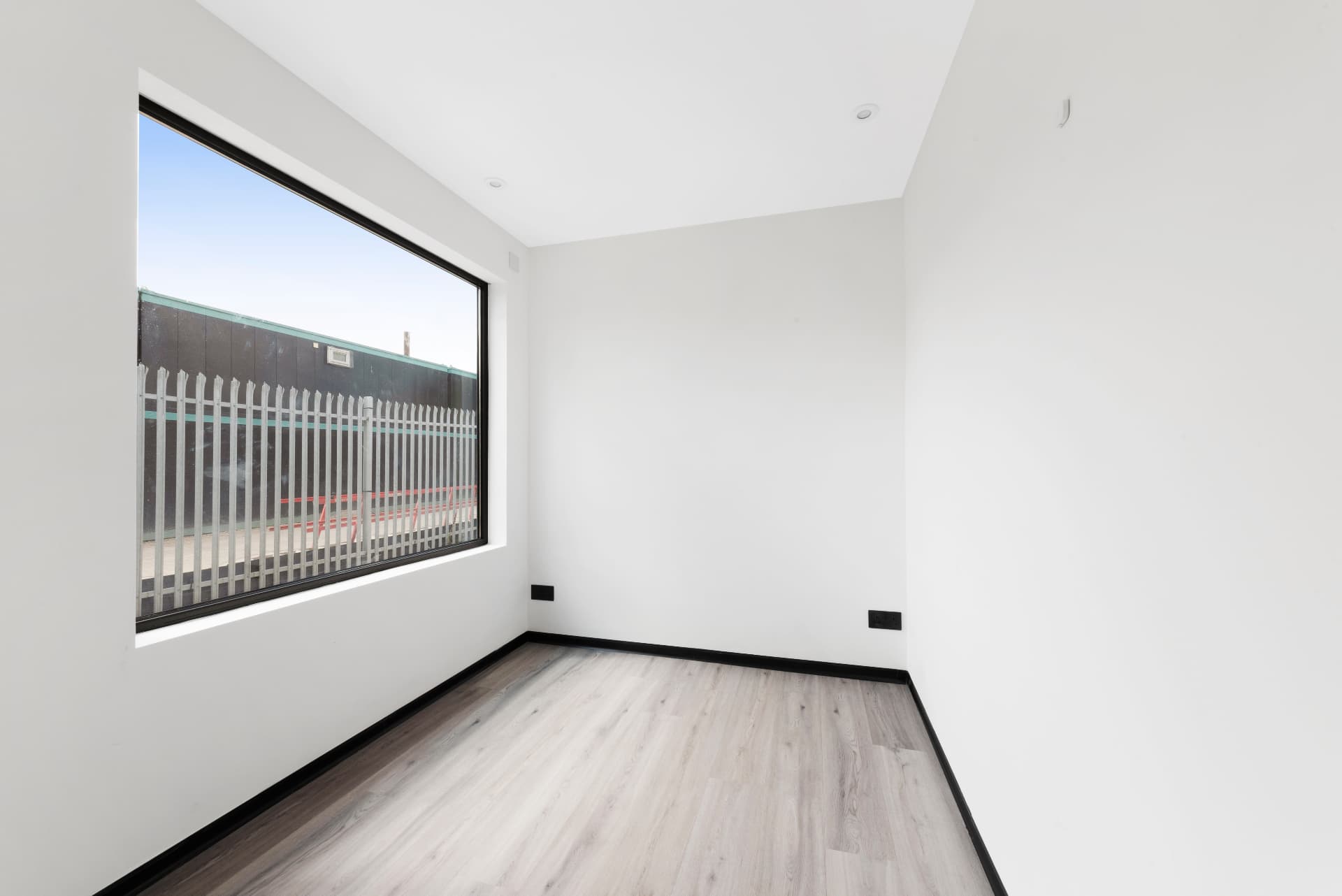 Bedroom with picture window inside a 40 ft container conversion