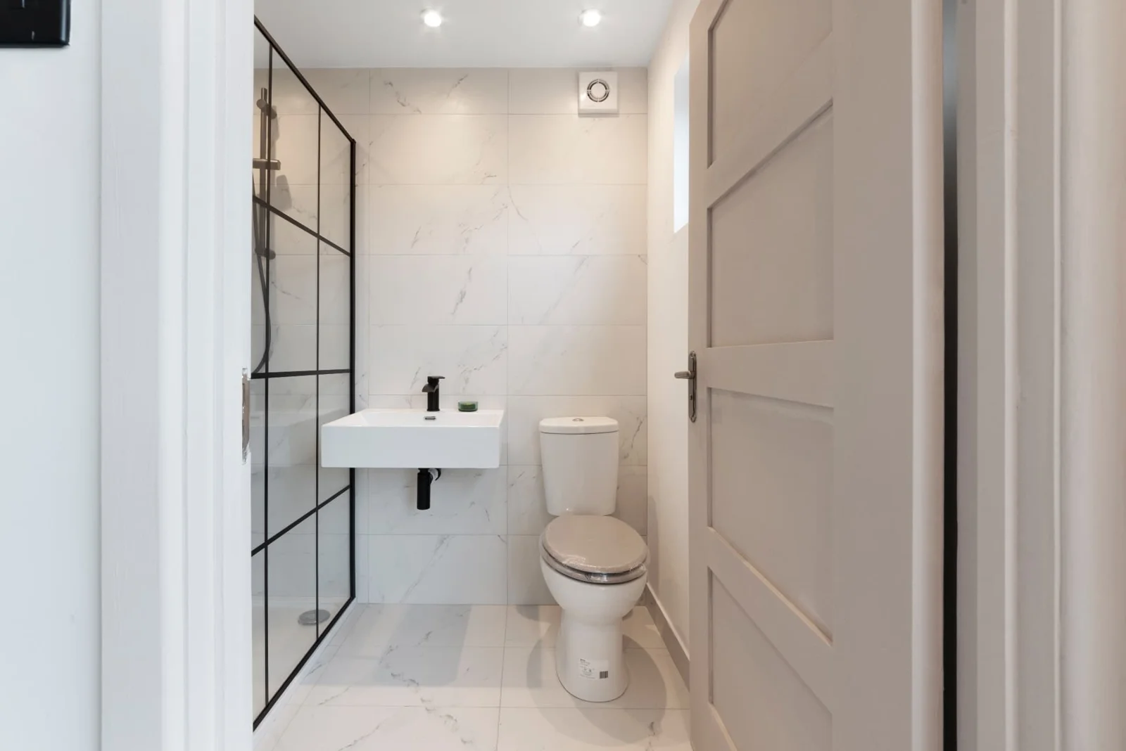 Residential Unit 27 shower room with basin, toilet and black-framed shower