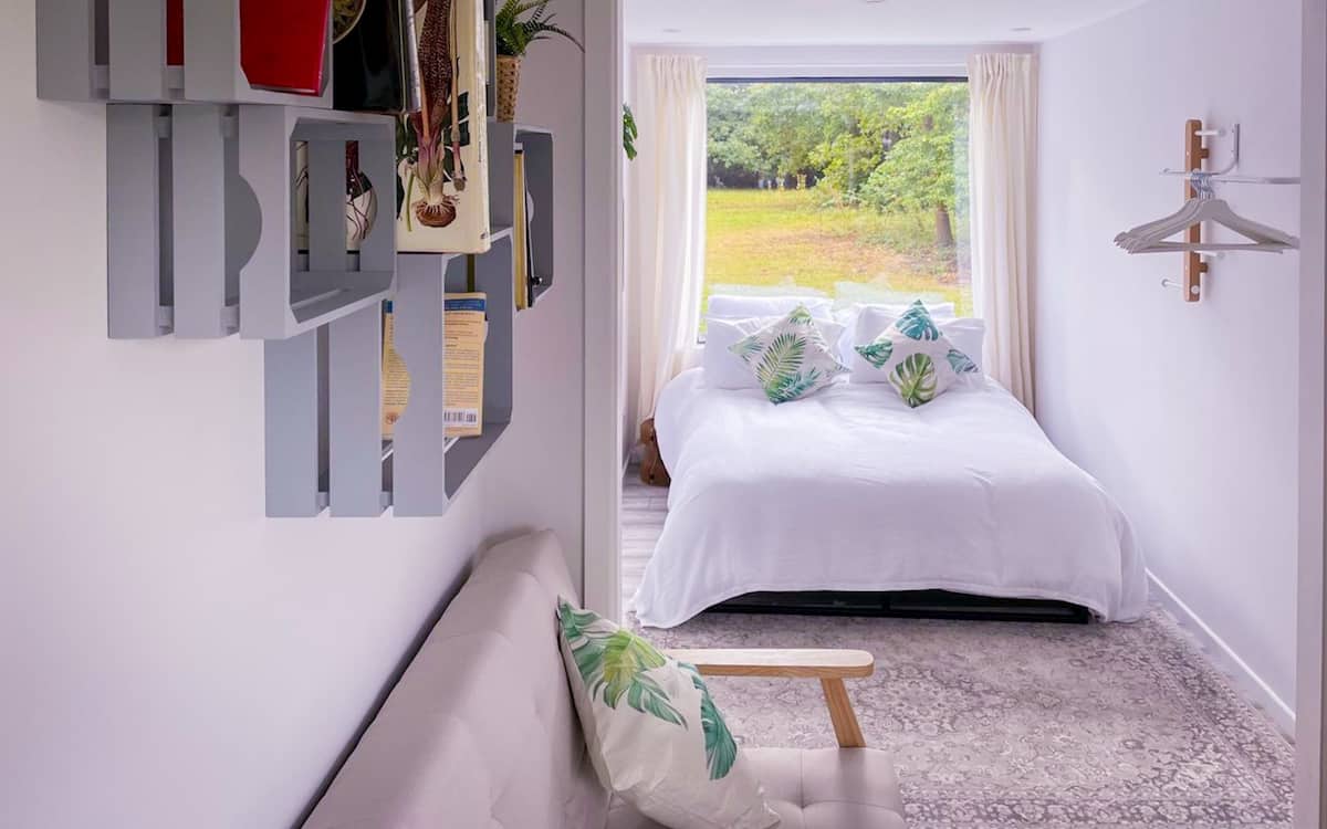 Exterior view of a converted shipping container holiday retreat in a secluded Bedfordshire woodland