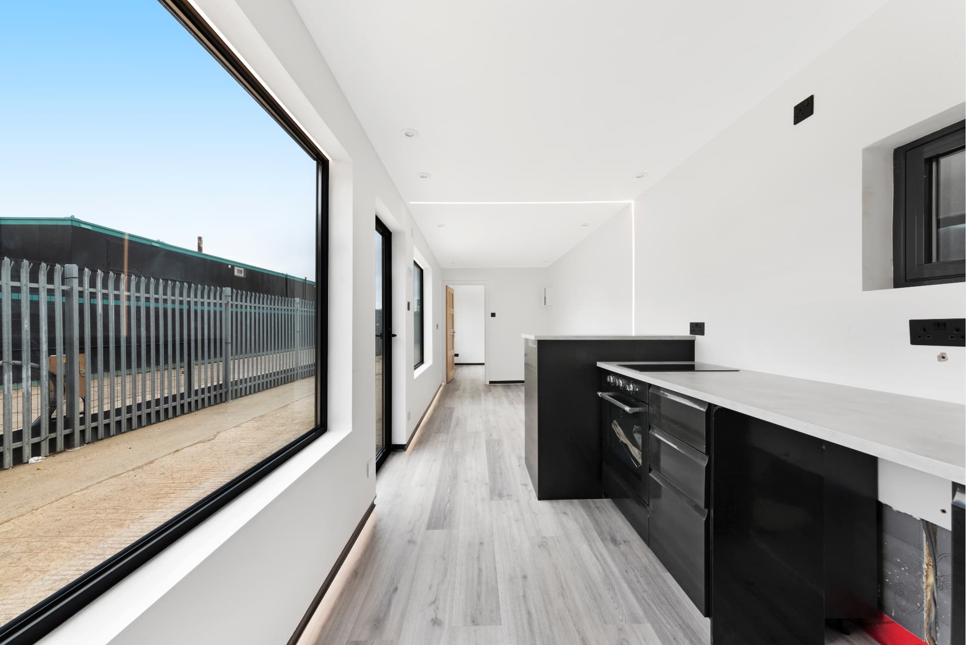 Large picture window and kitchen run inside a 40 ft container conversion