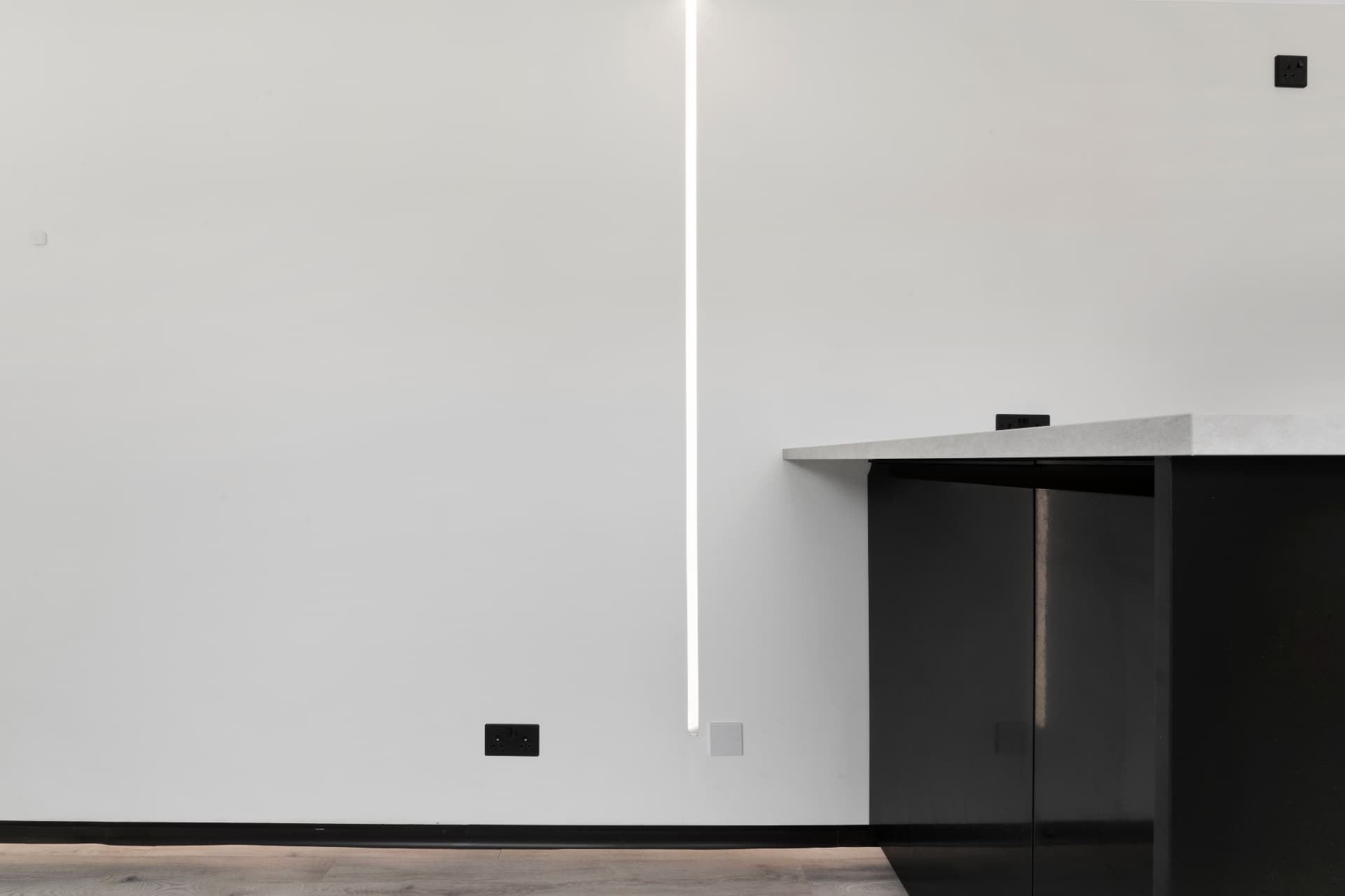 Detail of linear LED lighting and worktop edge inside a container conversion